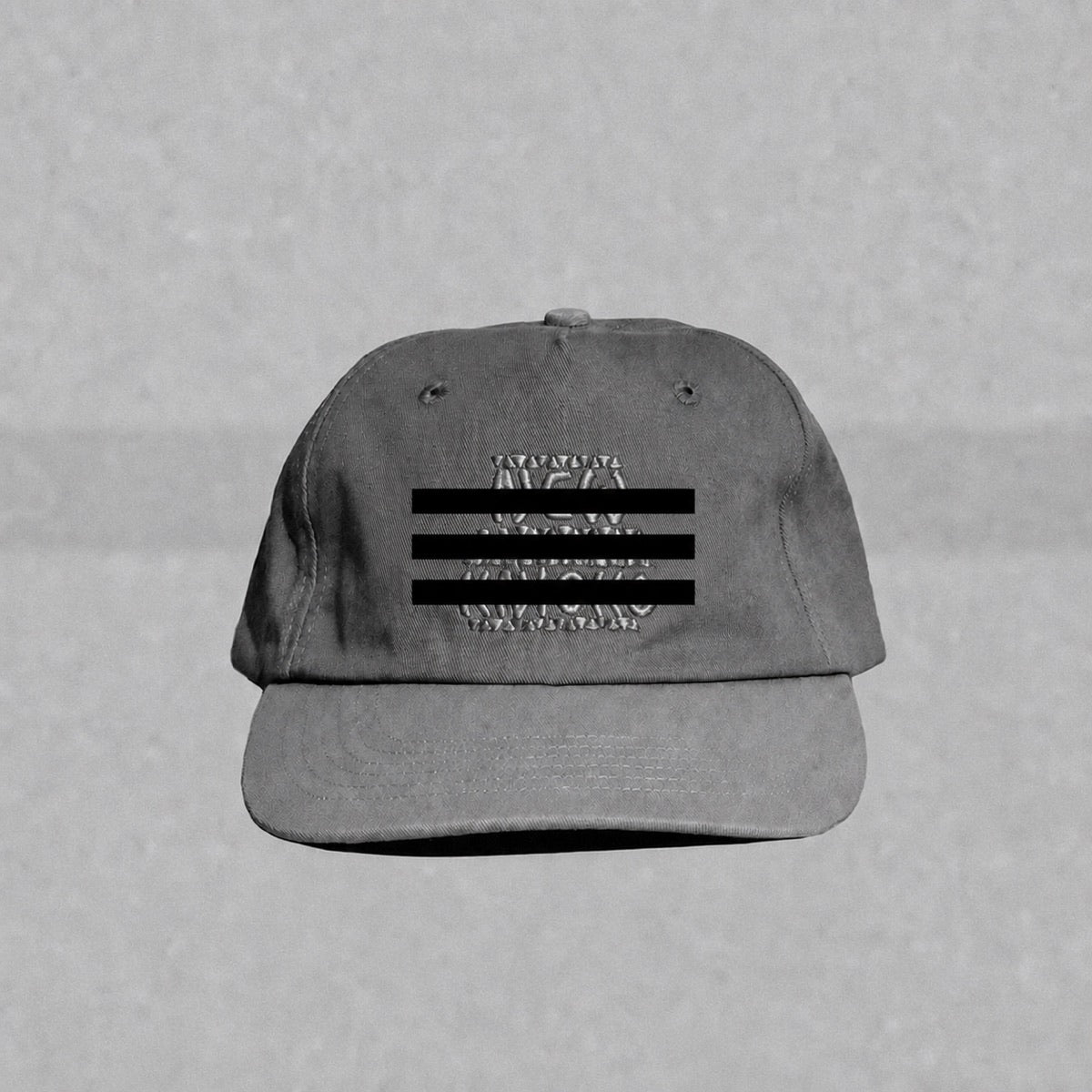 Black-and-white New York basketball parody hat with three redaction lines across its embroidery