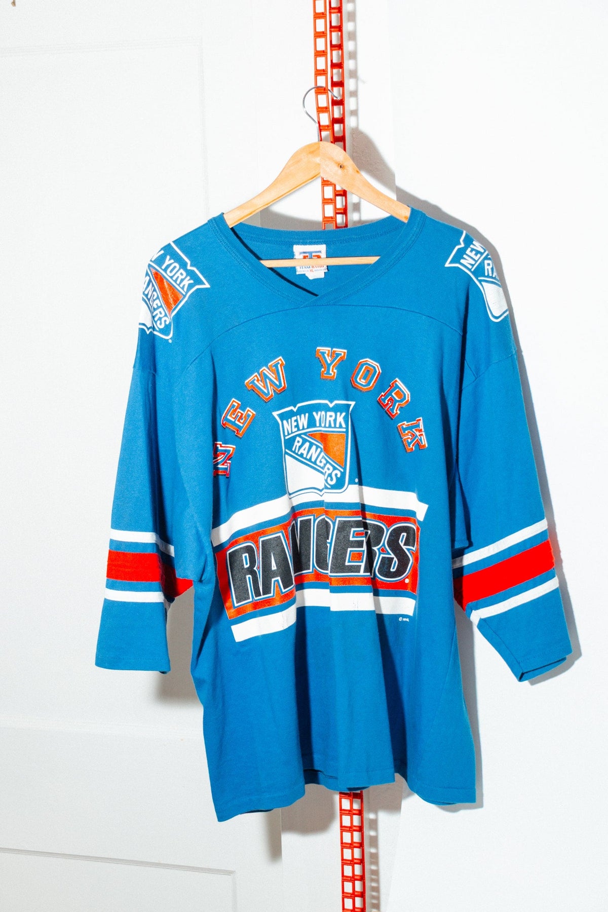 Vintage New York Rangers 3/4 sleeve tee in royal blue on a hanger, front
