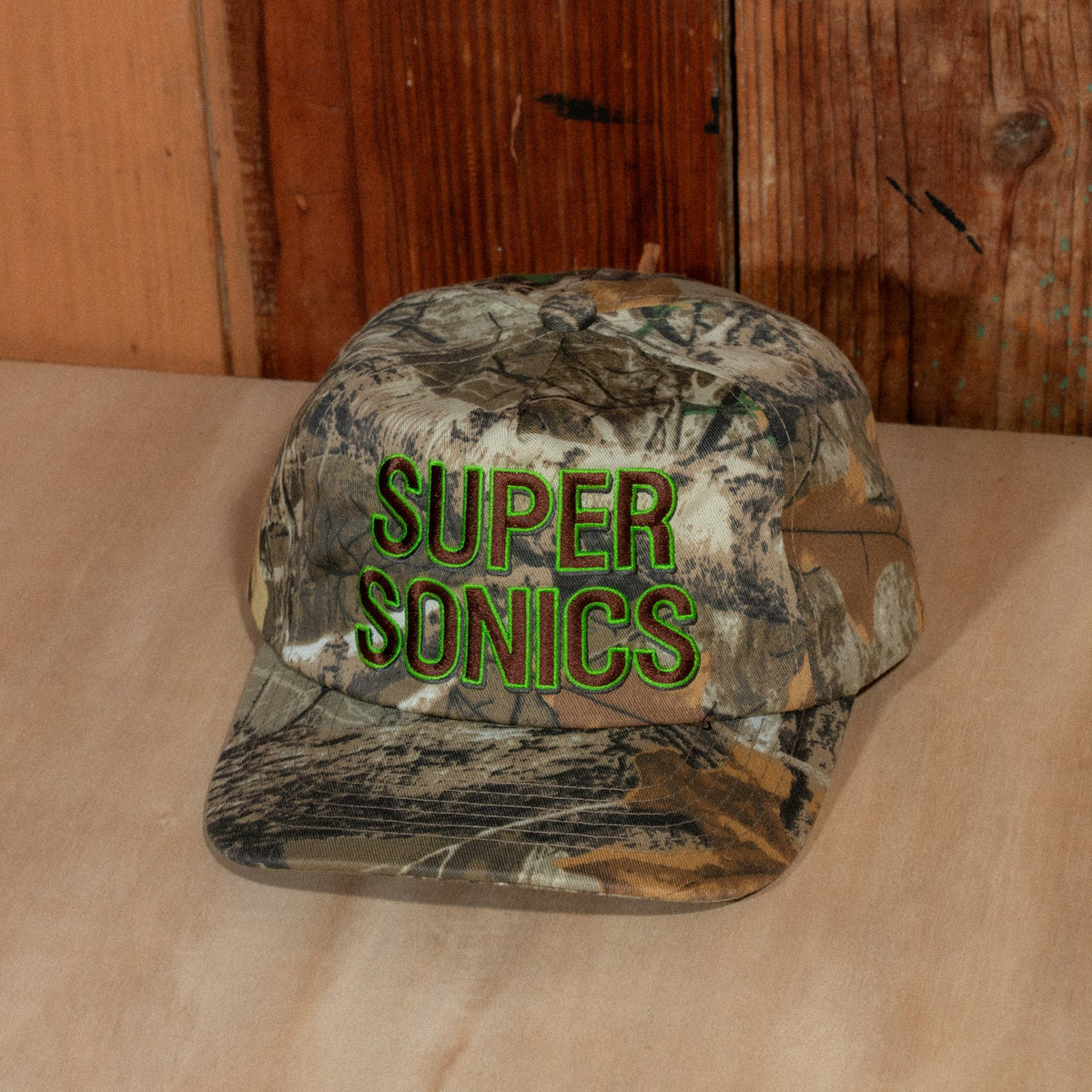 Peak Sonics Hat from slightly right of front, showing the unstructured camo crown and embroidery