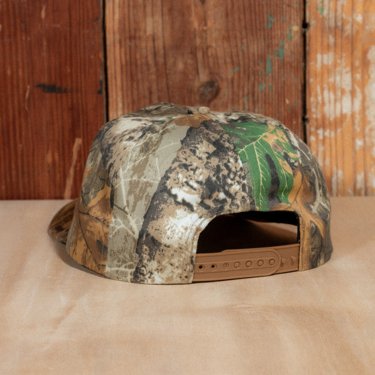 Back of the Peak Sonics Hat with a tan snapback closure