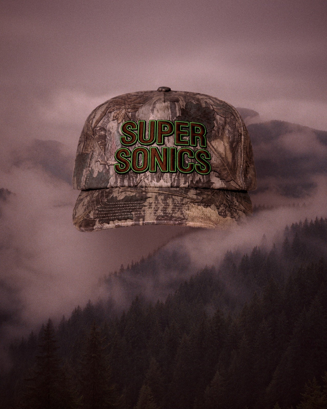 A camouflage Super Sonics hat emerging through fog